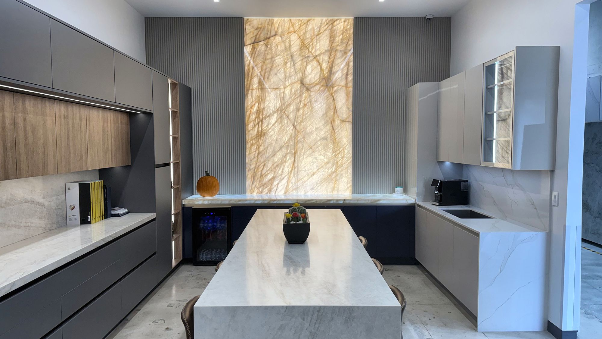 Kitchen display with backlit onyx wall at the All Stones FL showroom in Doral